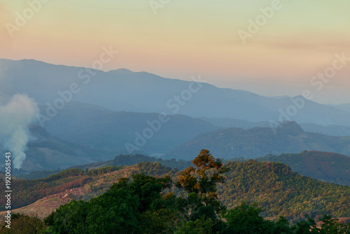Scenic view of warm sunlight on tropical mountain during sunset