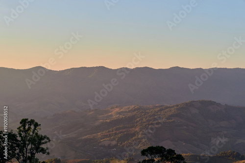 Scenic view of warm sunlight on tropical mountain during sunset