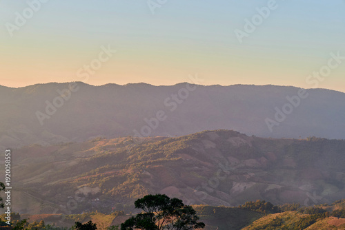 Scenic view of warm sunlight on tropical mountain during sunset