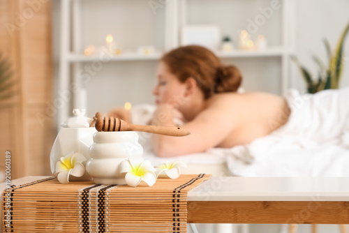 Jars of honey with spoon an...