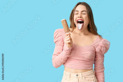 Young woman licking chocola...
