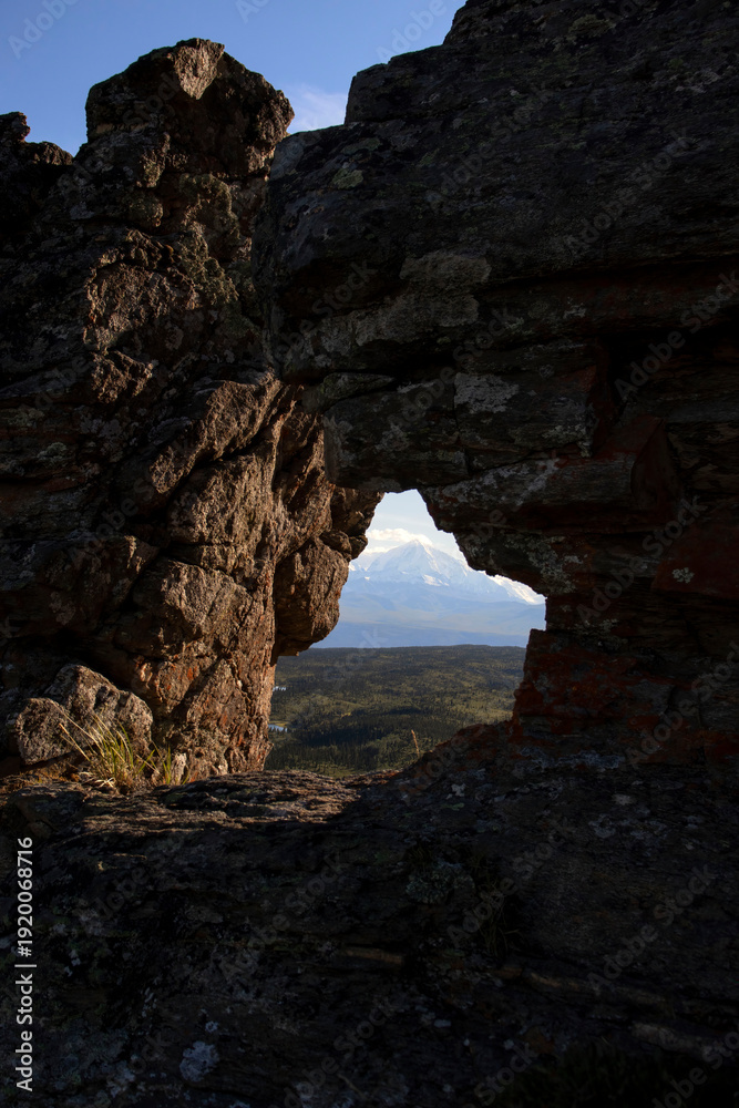 Fototapeta premium Mountain through a hole in rocks