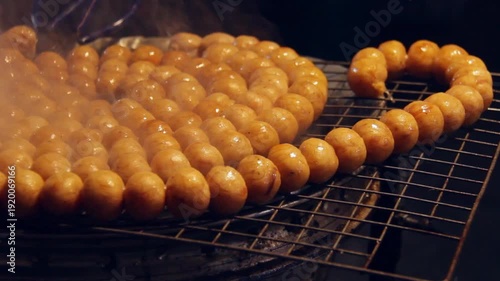 Pork Balls Grilled, on a hot stove countryside market in thailand blurred background
