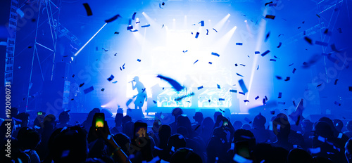 Cheering crowd with hands raised at concert. Summer and festival vibes