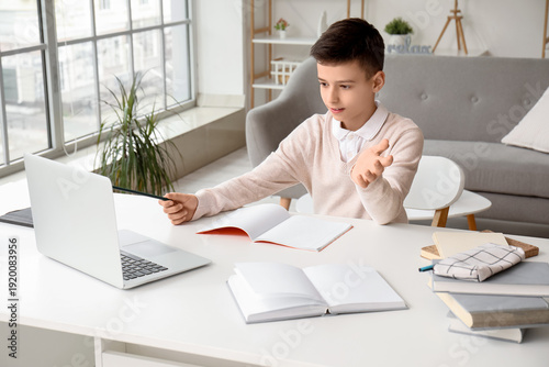Little boy studying online ...
