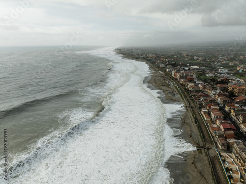 Storm surge destroys homes and buildings near the beach, ocean waves raging
