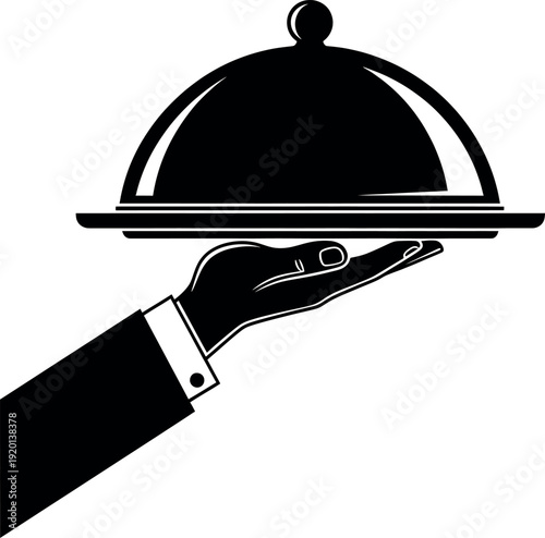 A waiter serving food under a covered dish on a tray