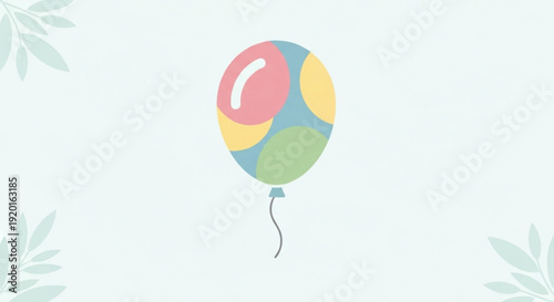 Colorful balloon floats gently in air with leafy background symbolizing joy and celebration