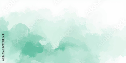 Foggy mountain landscape at sunrise with blue sky, forest hills and glowing sunlight over misty summer panorama