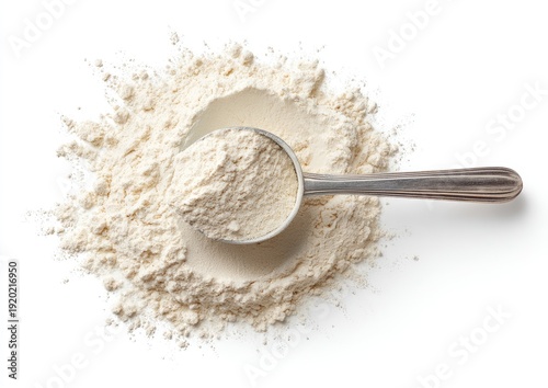 Overhead shot of a scoop overflowing with light powder on a white background