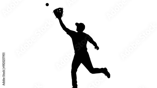 Silhouette of a baseball player catching a ball.