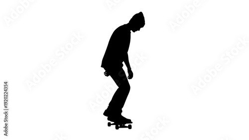 Silhouette of a Skateboarder Performing a Trick in Studio.