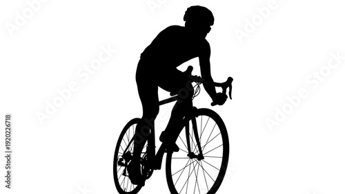 Silhouette of a cyclist riding a bicycle.