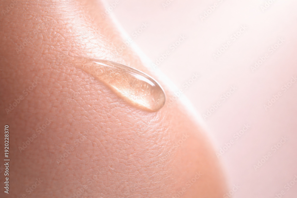 Fototapeta premium Hydration meets luxury in this skincare image showcasing smooth texture of serum drop on skin, emphasizing essence of beauty