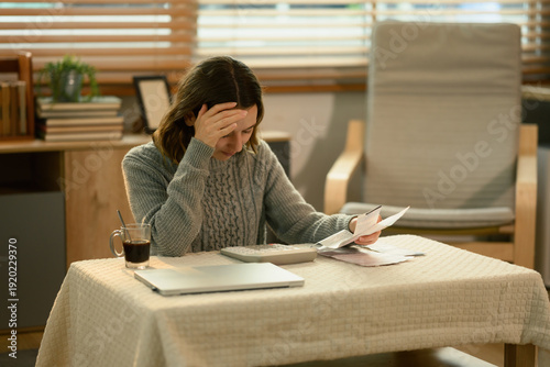 Картината върху платно White woman overwhelmed by financial pressure, analyzing documents and thinking
