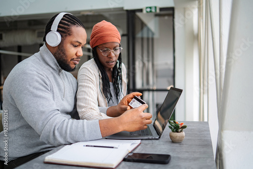 Wallpaper Mural Couple shopping online using laptop and credit card Torontodigital.ca