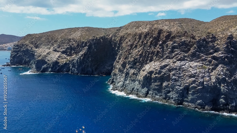 Obraz premium Tenerife coastline featuring rugged cliffs and deep blue ocean