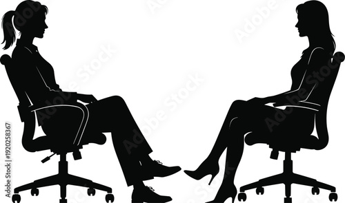 Two women sitting in office chairs in silhouette conversation