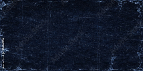 A dark blue vintage grunge paper background features a distressed wall texture and blank canvas material, creating a dirty old textile pattern design for a textured blackboard surface backdrop
