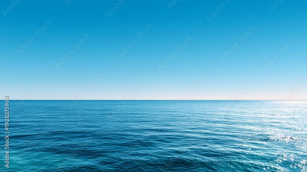 Obraz premium Infinite Blue Horizon: A serene view where the endless expanse of the deep blue sea meets the vast, clear sky, creating a sense of peace and tranquility.