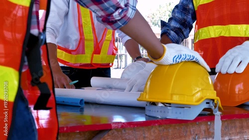 Structural engineer and architect and foreman worker with blueprints discuss, plan working for the building construction site office. Construction collaboration concept. 4K