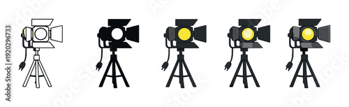 Row of five studio lights on tripods against gray backdrop