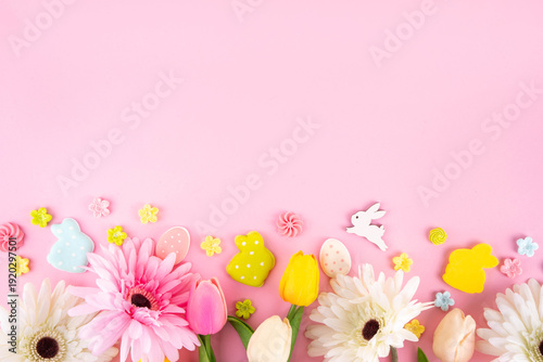 Beautiful spring flowers bouquet with Easter decorations on pink background
