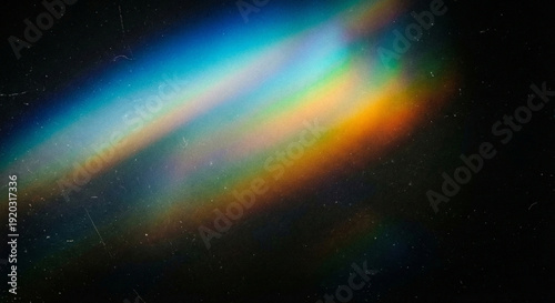 Canvas Print Vibrant rainbow light beam shining diagonally across a dark background with colo