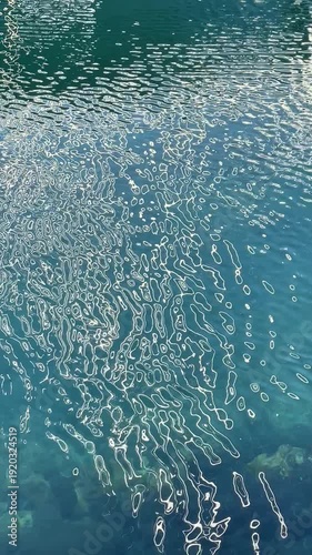 Sun reflection on the water. The sea. Vertical video of sunlight on the small waves.