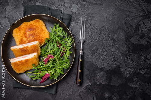 Fotografi Chicken cordon bleu cutlet with cheese and ham on plate with salad