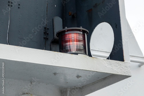 Valokuva A red navigational light on a big ship