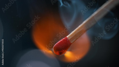 Match Igniting In Macro, Red Sulfur-Potassium Head Combusts And Emits Smoke Rising on a Blue Background