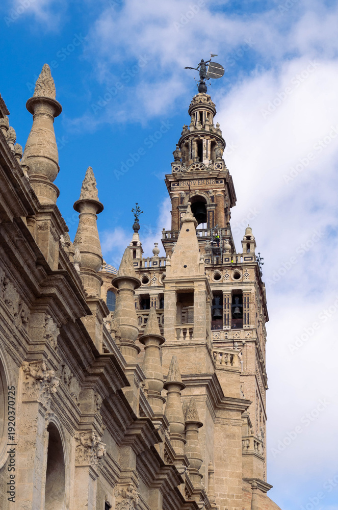Fototapeta premium Close-up of Giralda tower and El Giraldillo statue in Seville Cathedral, Spain.