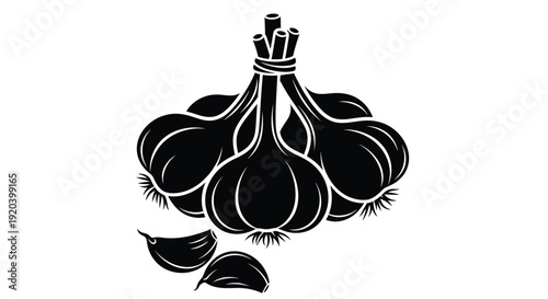 Black and white garlic bulb illustration with a dramatic silhouette