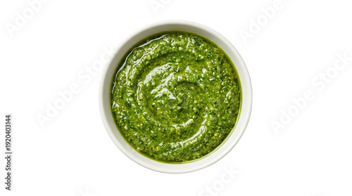 Bowl of vibrant green pesto sauce with a smooth texture and swirls on a plain white background no background