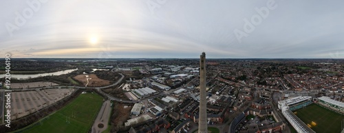 Northampton, United Kingdom - 14 February 2026: Aerial view of the National Lift Tower piercing the skyline, surrounded by urban sprawl and the River Nene winding through the landscape.