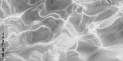 Obraz na plátne Abstract black and white image of rippling water surface with dynamic light refl