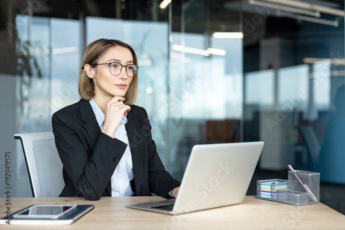 Fotografie Professional businesswoman analyzing data and planning new strategies while work