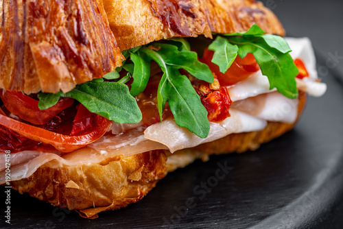 Konstfotografi Close up of savory croissant with prosciutto and arugula