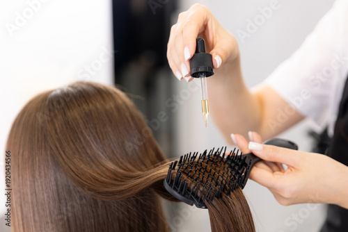 Schilderij op canvas Hair care routine with oil serum treatment and growth for young caucasian woman