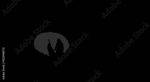 Silhouette of Two People Walking Together in a Dark, Moody Setting