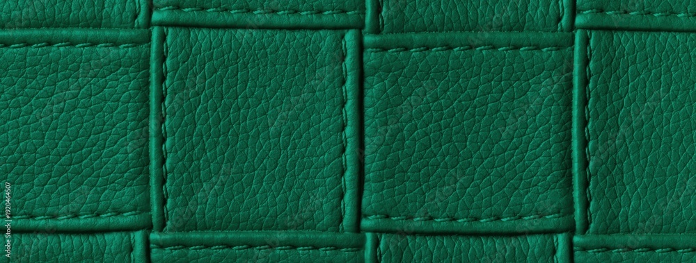 Fototapeta premium Texture dark emerald leather background with quilted stitched pattern, macro. Abstract deep green upholstery surface