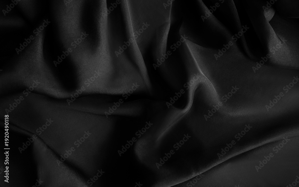 Obraz premium Luxury silk satin fabric background. Fashion elegant dark shade of white, grey and black. Smooth monochrome surface. Waves on the crumbled material. Abstract folds with shine. Dark smoke iron, jet