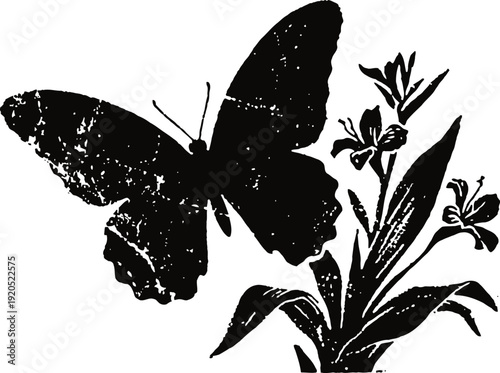 Black butterfly silhouette landing on a flowering plant with leaves and blossoms