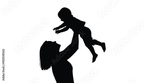 A woman playfully lifts a baby into the air