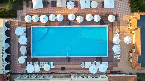 Aerial top-down view of a luxury resort swimming pool filled with turquoise water