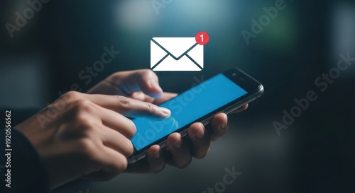 A person holding a smartphone with an email notification icon above the screen