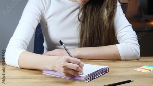 Writing in Daily Planner at Home