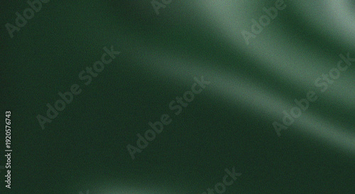 Dark green fabric with subtle folds and a smooth flowing texture