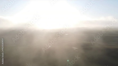 Misty Morning Landscape Wide shot of a minimalist, natural landscape, soft fog hugging the ground under diffused top light.